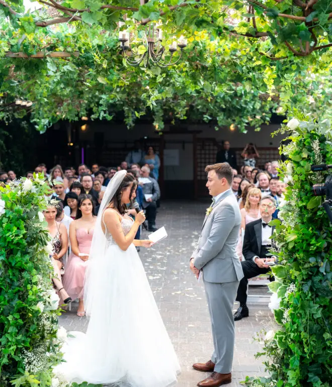 Bride and groom reading their vows during their ceremony