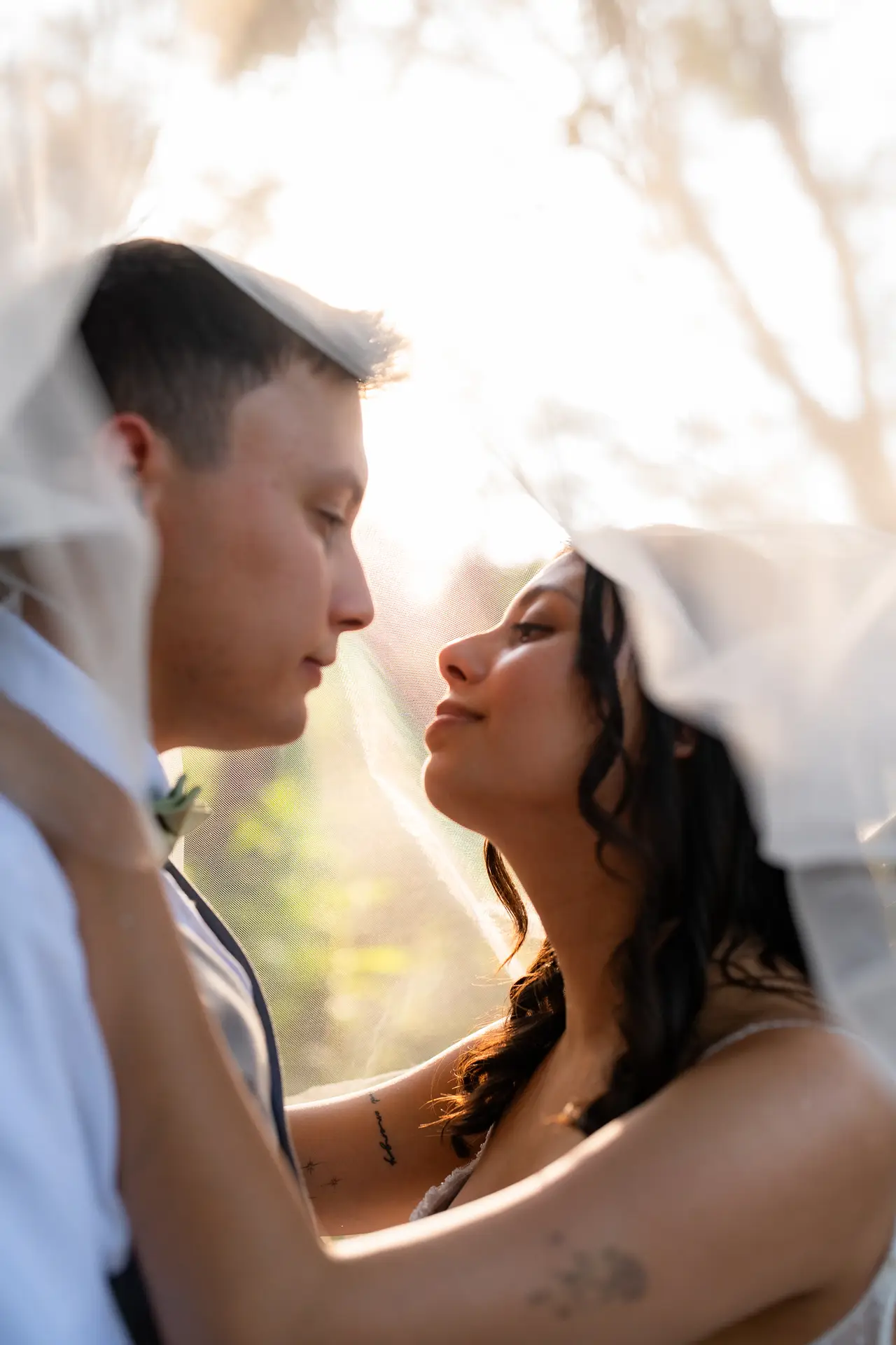 A man and woman kissing under the veil.