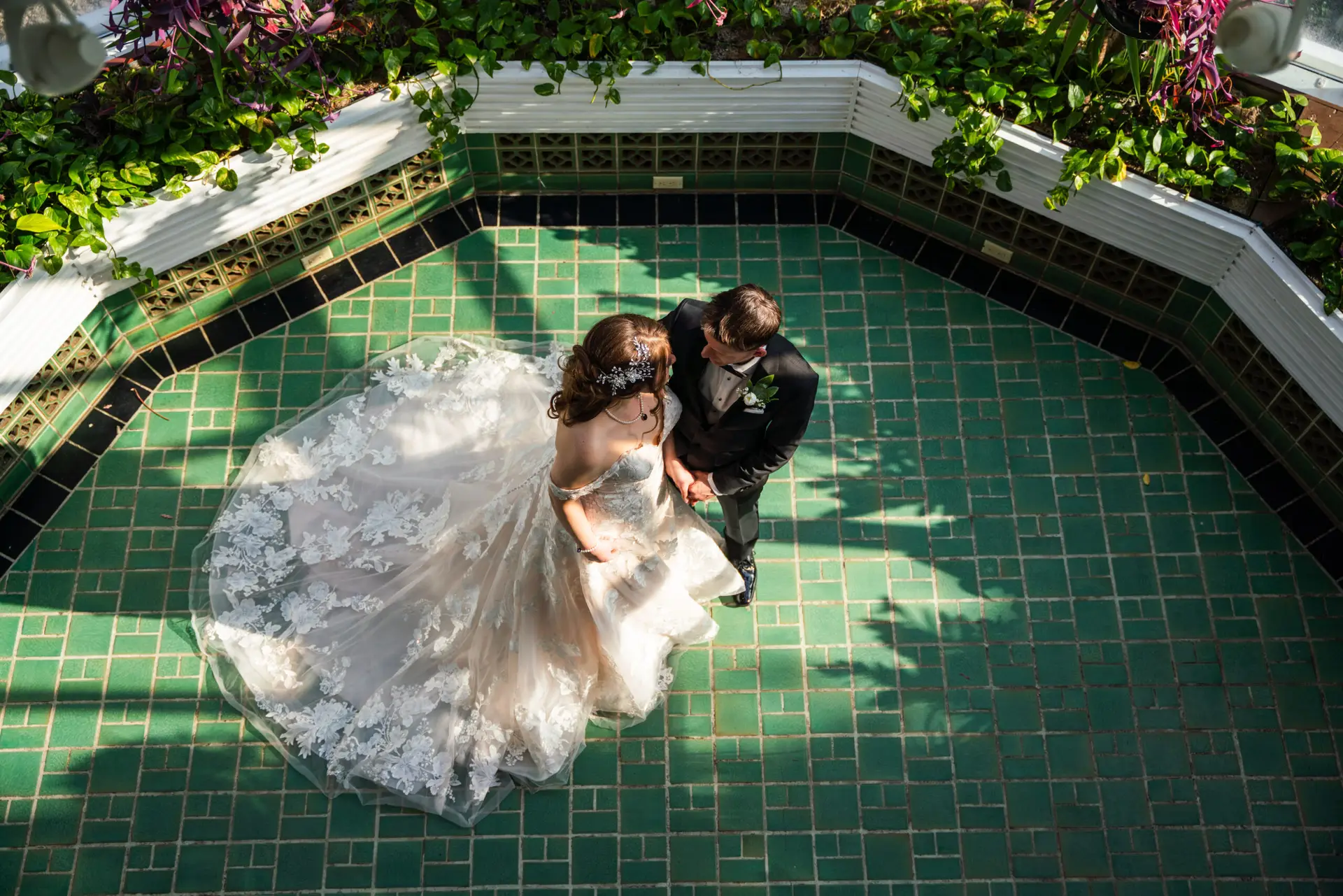 A bride and groom pose for the camera.