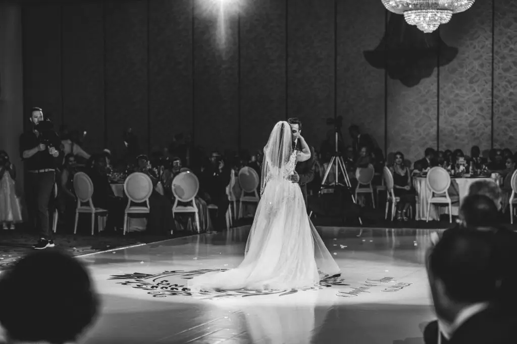 A bride in a white dress is on the dance floor