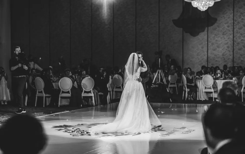 A bride in a white dress is on the dance floor