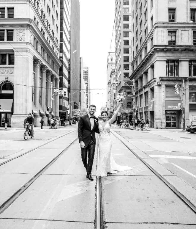 A man and woman standing on the side of a road.