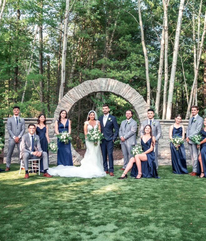 A group of people standing in front of trees.