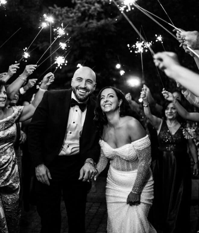 newly wed couple under sparklers at wedding reception