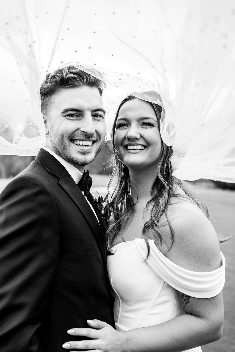 Bride and groom under veil