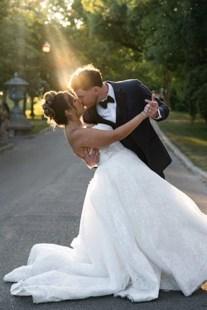 groom dipping bride at golden hour