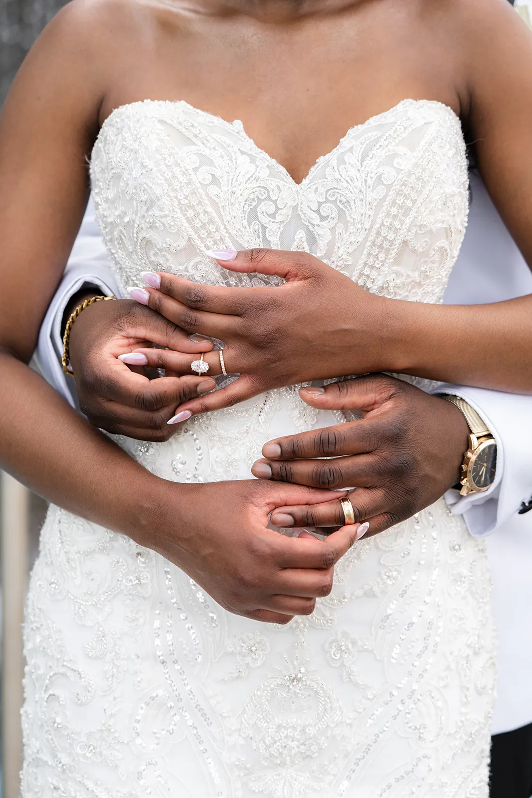 bride and groom holding each others rings