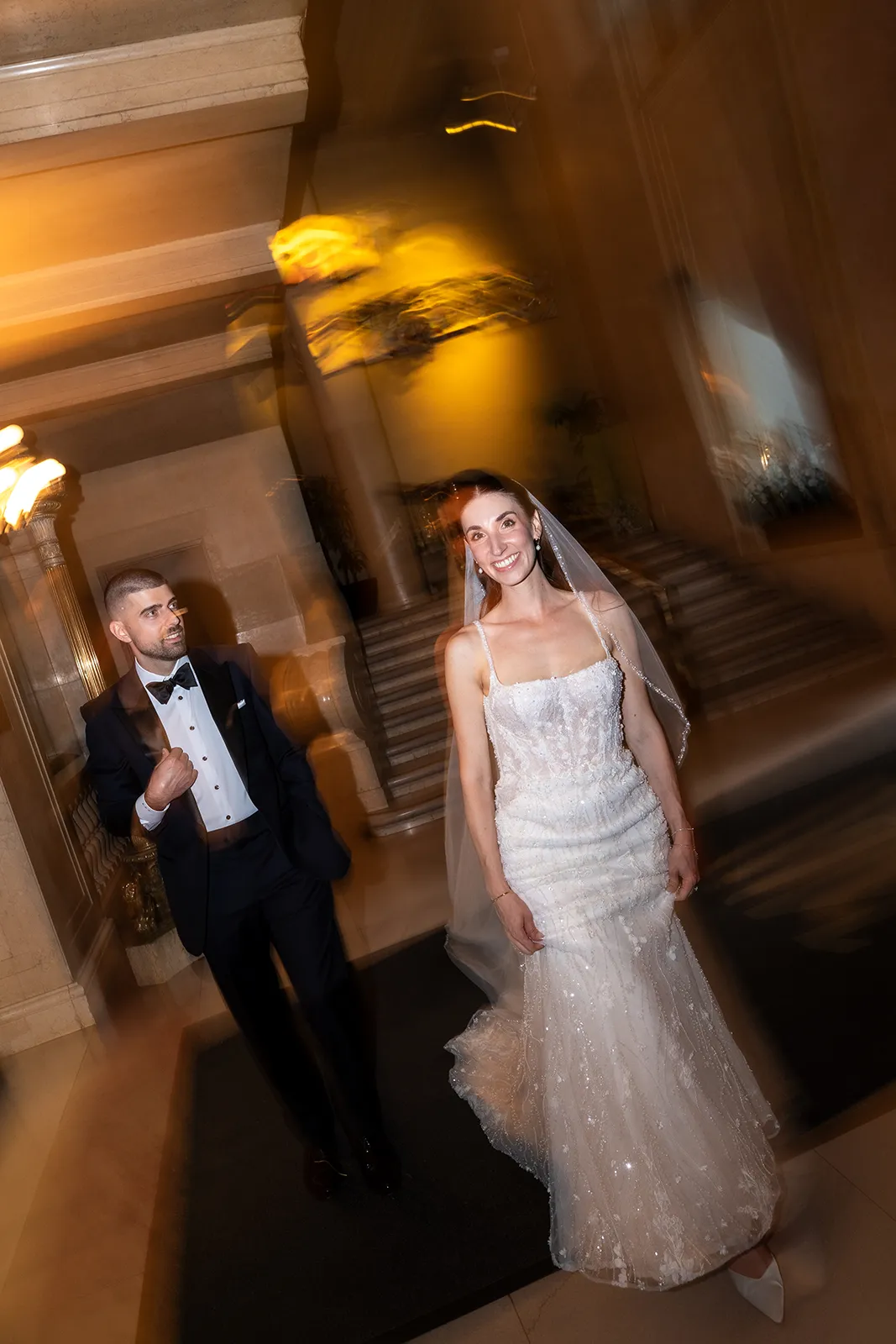 bride and groom walking through one king west hotel